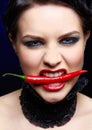 Beautiful brunette woman with red chilli pepper Royalty Free Stock Photo