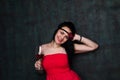 Beautiful brunette woman in red dress with a glass of red wine Royalty Free Stock Photo