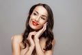 Beautiful brunette woman with red lipstick on lips. Close-up girl with beautiful make-up. Royalty Free Stock Photo
