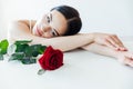 beautiful brunette woman with red rose flower Royalty Free Stock Photo