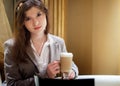 Beautiful brunette woman in restaurant drinking coffee