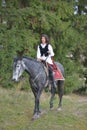 Beautiful brunette woman riding horse