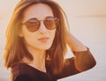 Beautiful brunette woman in round sunglasses