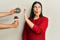 Beautiful brunette woman saying no to sweets on a healthy diet making fish face with mouth and squinting eyes, crazy and comical