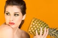 Beautiful brunette woman with slice of pineapple