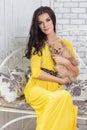 Beautiful brunette woman with small dog in hands Royalty Free Stock Photo