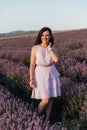 beautiful brunette woman standing in lavender purple flowers walk trip