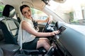 Beautiful brunette woman starting car with key Royalty Free Stock Photo