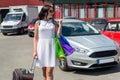 Beautiful brunette woman with suitcase and shopping bags Royalty Free Stock Photo