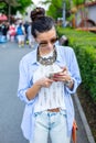 Beautiful brunette woman using smart phone in the city Royalty Free Stock Photo