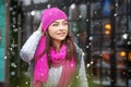 Beautiful brunette woman walking around the city in winter. Snow