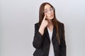 Beautiful brunette woman wearing business jacket and glasses pointing to the eye watching you gesture, suspicious expression Royalty Free Stock Photo