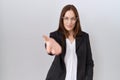 Beautiful brunette woman wearing business jacket and glasses smiling cheerful offering palm hand giving assistance and acceptance Royalty Free Stock Photo