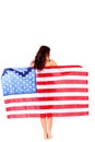 Beautiful brunette woman wrapped into American flag. Royalty Free Stock Photo