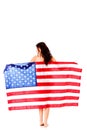 Beautiful brunette woman wrapped into American flag. Royalty Free Stock Photo