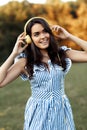 Beautiful brunette young woman with headphones listening modern music at the park. Royalty Free Stock Photo