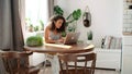 Charming young woman typing on laptop computer at home. Royalty Free Stock Photo