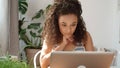 Charming young woman typing on laptop computer at home. Royalty Free Stock Photo