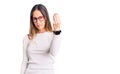 Beautiful brunette young woman wearing casual white sweater and glasses doing italian gesture with hand and fingers confident Royalty Free Stock Photo