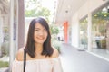 Beautiful brunette young woman wearing dress and walking on street. Royalty Free Stock Photo