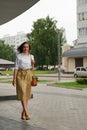 Beautiful brunette young woman wearing dress and walking on the street Royalty Free Stock Photo
