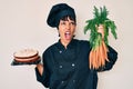 Beautiful brunettte woman chef cooking carrot cake angry and mad screaming frustrated and furious, shouting with anger Royalty Free Stock Photo