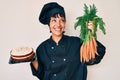 Beautiful brunettte woman chef cooking carrot cake smiling looking to the side and staring away thinking Royalty Free Stock Photo