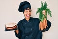 Beautiful brunettte woman chef cooking carrot cake winking looking at the camera with sexy expression, cheerful and happy face Royalty Free Stock Photo