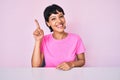 Beautiful brunettte woman wearing casual clothes over pink background pointing finger up with successful idea Royalty Free Stock Photo