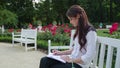 Lady Sitting in the Park and Writing Royalty Free Stock Photo