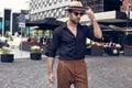 Beautiful brutal tanned muscular hipster man posing in the streets Royalty Free Stock Photo