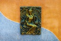 Beautiful Buddhist wall plaque in Krabi, Thailand on a colorful building