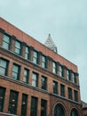 Beautiful building with dark-framed windows against a cloudy sky on a gloomy day