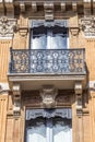 Beautiful building detail. Ornate facade with iron balconies. Toulouse, France