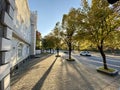 Beautiful building, trees and a car with a road