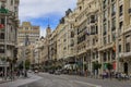 Beautiful buildings on the famous Gran Via shopping street and people walking in the center of the city in Madrid, Spain Royalty Free Stock Photo