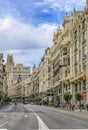 Beautiful buildings on the famous Gran Via shopping street and people walking in the center of the city in Madrid, Spain Royalty Free Stock Photo