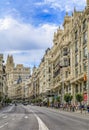 Beautiful buildings on the famous Gran Via shopping street and people walking in the center of the city in Madrid, Spain Royalty Free Stock Photo