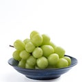Beautiful a bunch of Shine Muscat green grape on a blue plate isolated on white background Royalty Free Stock Photo
