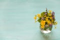 Beautiful bunch of wild spring flowers in a glass vase on the turquoise background. Spring bouquet of flowers Royalty Free Stock Photo