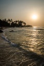 Beautiful Bureh Beach during sunset with silhouettes of palms and surfers, Sierra Leone, Africa Royalty Free Stock Photo