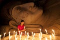 A beautiful Burmese girl to pay her respect to the Buddha statue.