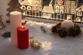 Beautiful burning candles with Christmas decor near window, space for text Royalty Free Stock Photo