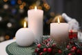 Beautiful burning candles and Christmas decor on white table indoors Royalty Free Stock Photo