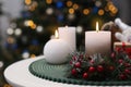 Beautiful burning candles and Christmas decor on white table indoors, space for text Royalty Free Stock Photo