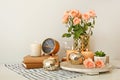 Beautiful burning candles with rose flowers, books and alarm clock on table Royalty Free Stock Photo