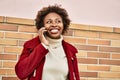 Beautiful business african american woman with afro hair smiling happy and confident outdoors at the city having a conversation Royalty Free Stock Photo