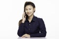 Beautiful business Asian woman wearing blue shirt smile talking in smartphone to get ideas and business plan Royalty Free Stock Photo