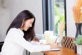 Beautiful business asian young woman writing on notebook on table Royalty Free Stock Photo