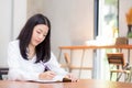 Beautiful business asian young woman writing on notebook on table Royalty Free Stock Photo